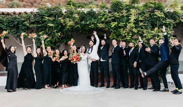 Entire wedding party on the steps of the Hacienda at the Ramona Bowl Amphitheatre