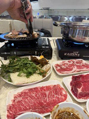 Hot pot + kbbq. (Plated meats are for hot pot, kbbq meats are DIY at the bar)