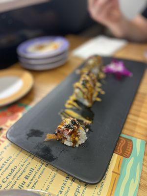 Sushi roll with a steak on top