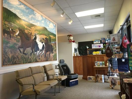 Advanced Chiropractic waiting room with a portrait of Dr. Greg's horses