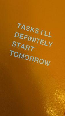A notebook that says Tasks I'll Definitely Start Tomorrow.