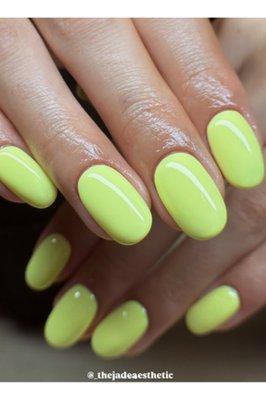 These nails are a bold and trendy neon yellow with a high-gloss gel finish -- perfect for summer vibes and making a statement