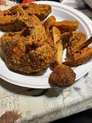 Chicken, potato wedges and fried pickles.