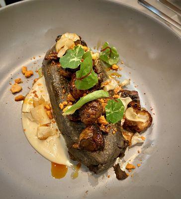 Blue corn Tlacoyo with black bean filling, and sunchokes.