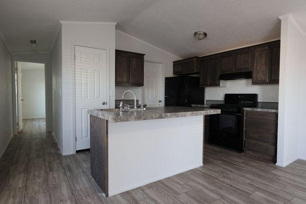 an empty kitchen with an island in the middle of it