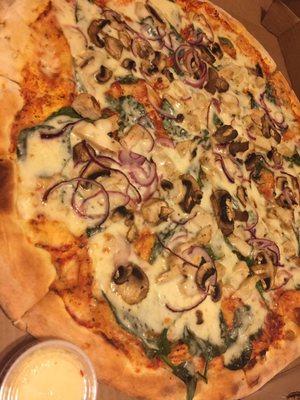 Large veggie pizza with additional chicken breast topping