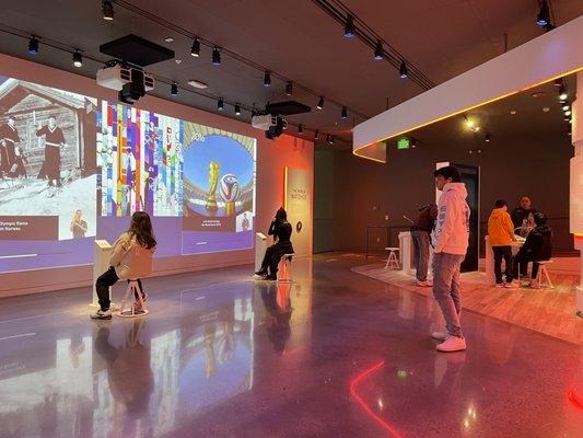 interactive room: learning about the olympics throughout the years (to the left) | screen to interviewing athletes (back left)