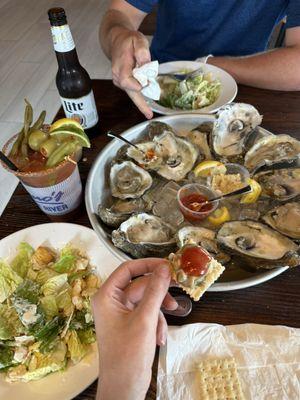 Dozen raw oysters, side cesar salad & Bloody Mary special