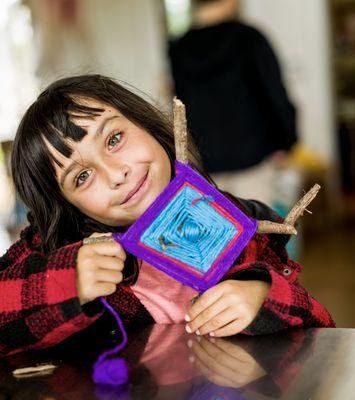 Our students love getting creative! This young learner proudly shows off a hands-on project made during a fun, educational visit.