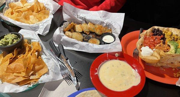 Chips guacamole and queso, fried cucumbers, and a taco salad.