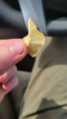 Piece of paper, perhaps used to wrap butter. A little bigger than the size of a quarter