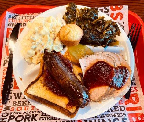 Two meat plate with sausage, turkey, collards and potato salad.
