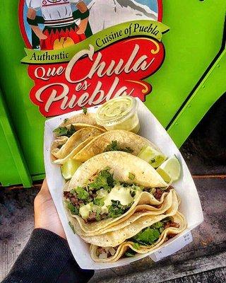 Four Asada tacos w/ lime and verde sauce.