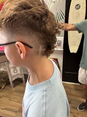 Patrick Mahomes inspired burst fade with a cross.