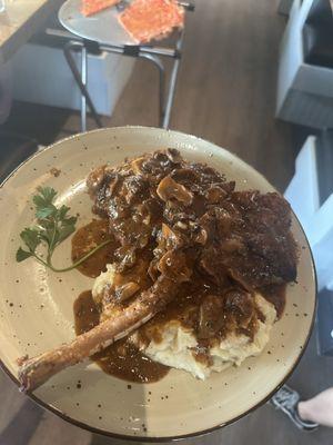 Mashed potatoes, pork chop tomahawk in a Marsala mushroom Demi