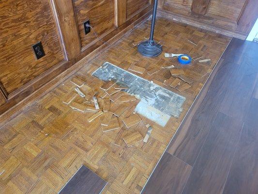 This is the area they wanted to fill with cement and relay the laminate floor back over. Patch job! Unprofessional.