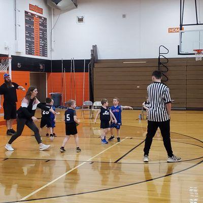 Coaches from both teams are assisting the young 5 year Olds playing basketball inside Almont High School. 2/4/2024