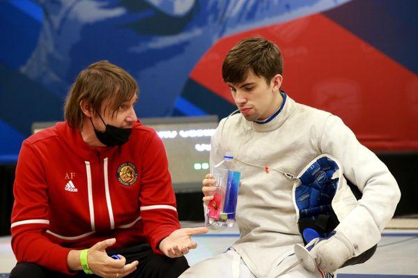 Coach Alex with fencer during a break.