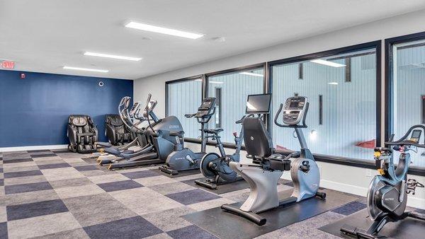 A gym with a row of exercise bikes.