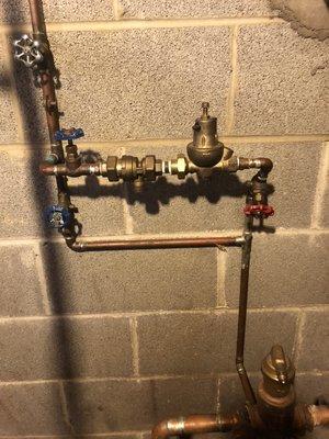 Serviceable back flow preventer and pressure reducing valve with a bypass.
