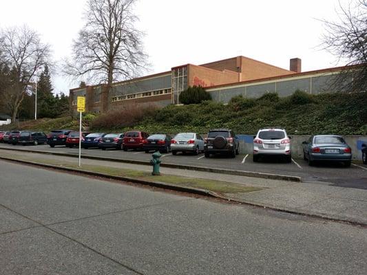 The school from the side with the bus leading zone below.