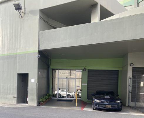 Back entrance to the building coming from the parking area. As you entered inside, take a left.