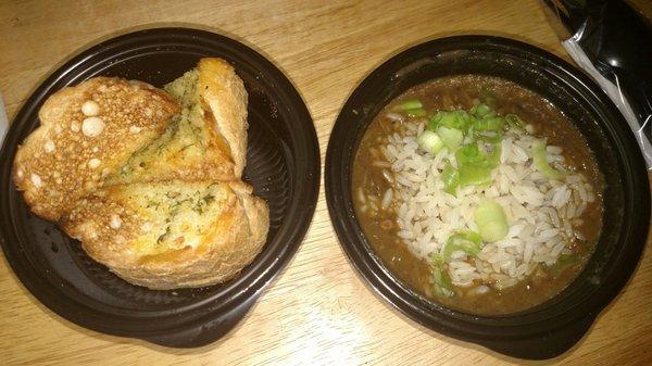Garlic bread and a cup of seafood gumbo