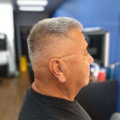Bald fade with short layers.