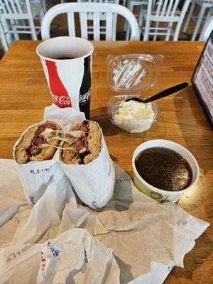 French Dip sandwich on wheat bread with au jus, potato salad & Diet Coke