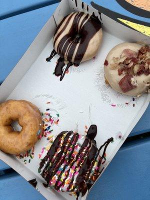 Left side glazed and Beach Ball. Right side Peanut Butter In Paradise and Maple Bacon