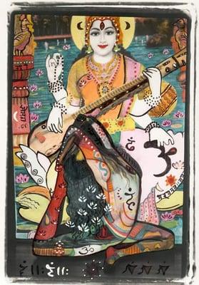 Kitty in eka pada kapotasana, with Goddess Lakshmi slide projection.