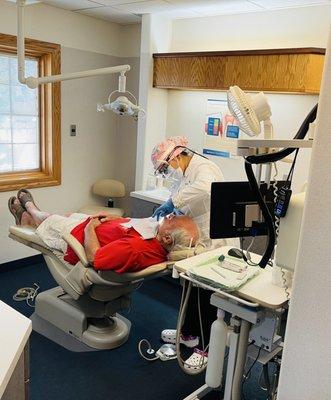 Dr. Gagneet Grewal DDS doing procedure on her patient .