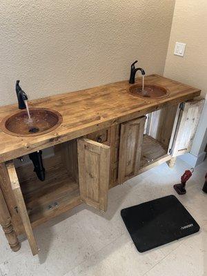 Finish work installed vanity with copper sinks and matte black DELTA faucets
