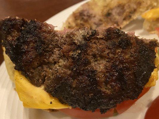 Burnt cheeseburger.