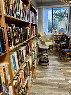 Shelves of books and sitting area.
