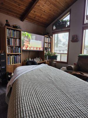 A massage table set up in a living room ready for massage.