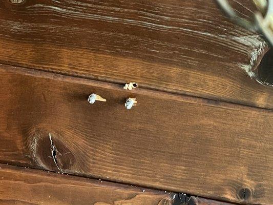 Extra hole. It's difficult to tell that there are beams on these ceilings but there are and that's where the screws SHOULD have been placed