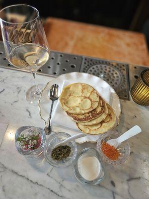 Golden Osetra Caviar, Trout roe , Crème Fraîche-Queso Oaxaca, pickled red onion, cilantro flowers, Crêpes de Maïs