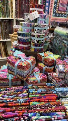 Lots of pre-cut fabric bundles for your quilt projects.