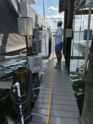 Spraying boats on a customers dock
