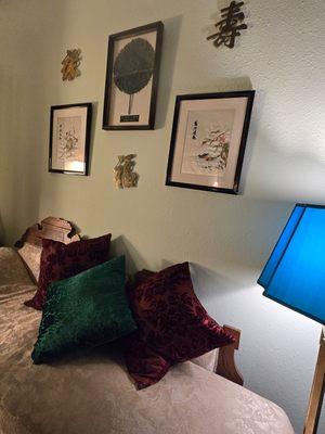 A cozy sofa where you can tell me what you want from your Reiki healing session or tarot card reading.