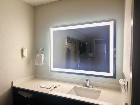 Bathroom area has a nice mirror!