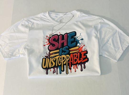 "Embrace unstoppable strength with this 'She is Unstoppable' tee. This unisex shirt features a powerful message celebrating relentless deter