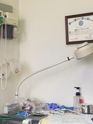 DOCTOR ARTHUR A POLUSSA. The table is dirty, with a blood-stained napkin on it. This poses a potential hygiene and safety risk.