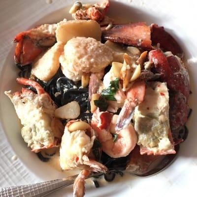 Squid ink fettuccine with seafood in garlic cream sauce; very good and generous amount of pasta and seafood! $34