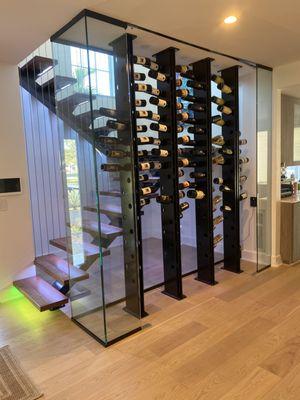 Floating Staircase with wine rack.