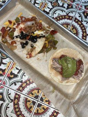 Veggie taco(eaten) / pork carnitas taco
