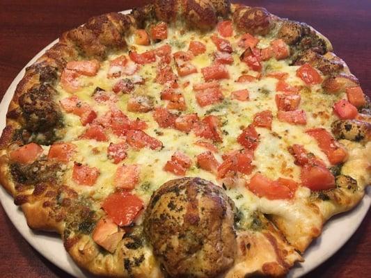 Pesto based pizza with mozz, parm, and tomato. So good! And took half of it home.