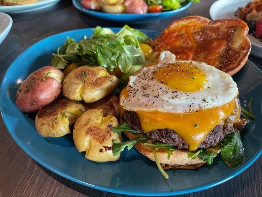 Australian wagyu burger with side of organic salad and smashed potatoes