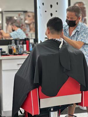 My husband getting his hair cut by Jason
